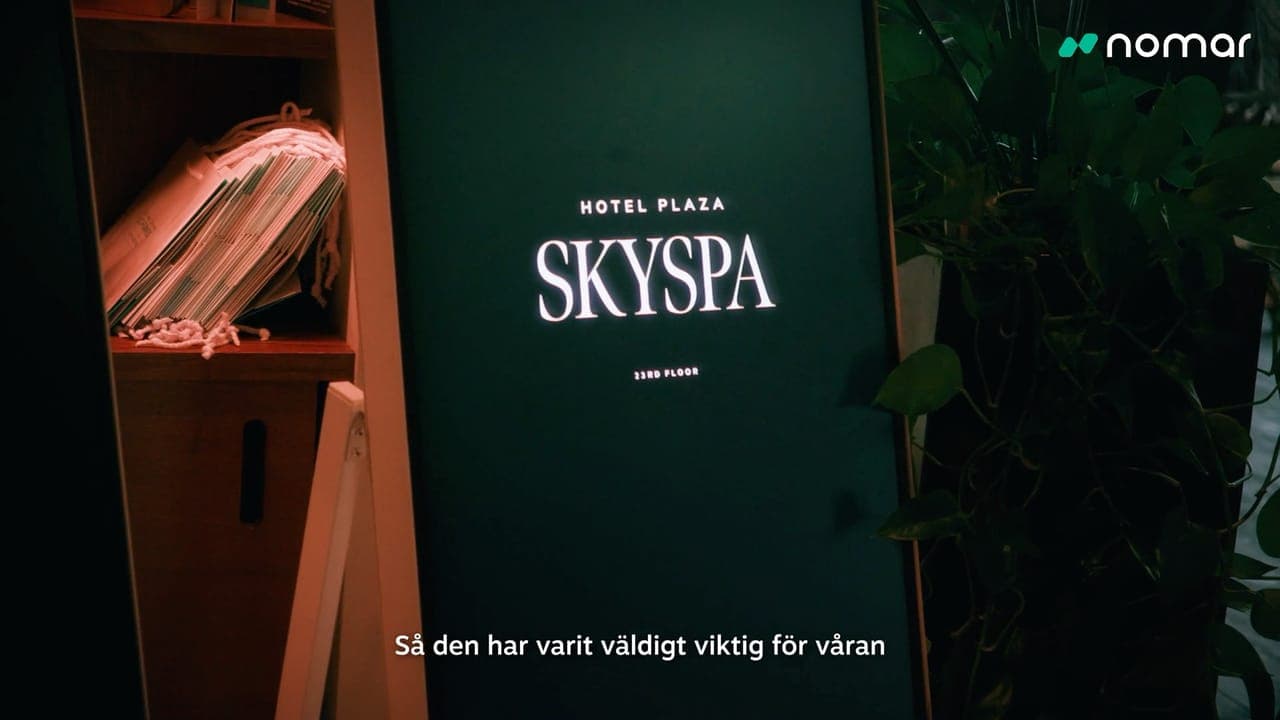 The lit sign for Hotel Plaza Skyspa on the 23rd floor, a still from the customer story.